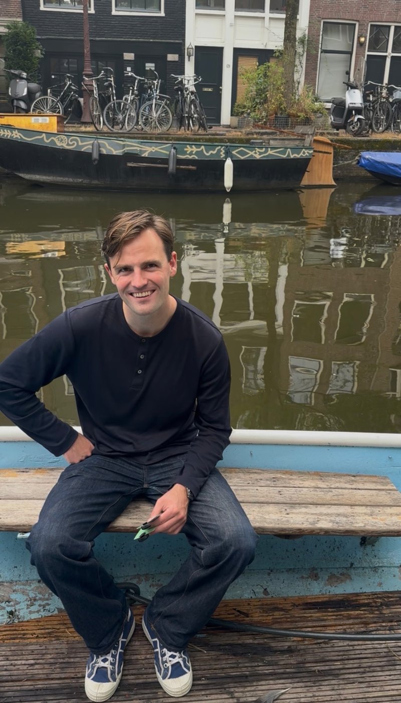 Sitting on the boat at the quay in front of an old barge